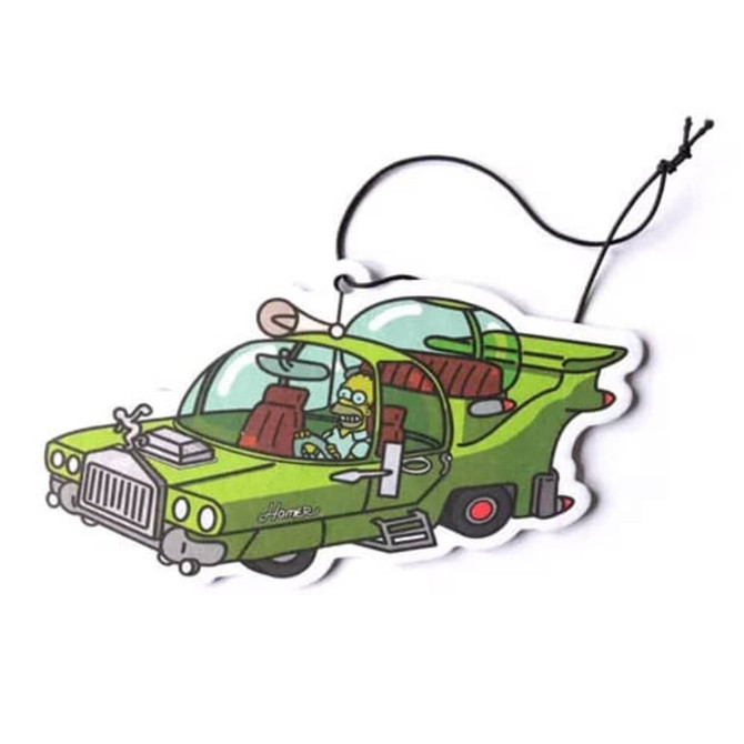 A green car air freshener shaped like a cartoon vehicle, featuring a character inside and a hanging string.