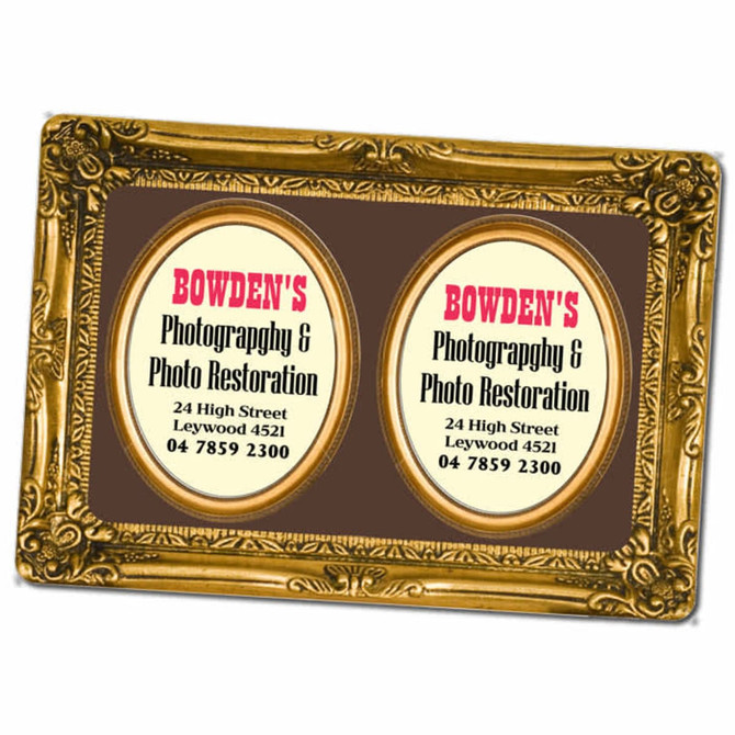 A decorative gold magnetic photo frame featuring two oval spaces for photos or information, set against a brown background.