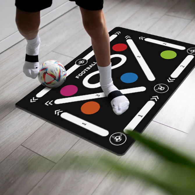A football training mat featuring a black design with colourful markers and pathways for training activities.
