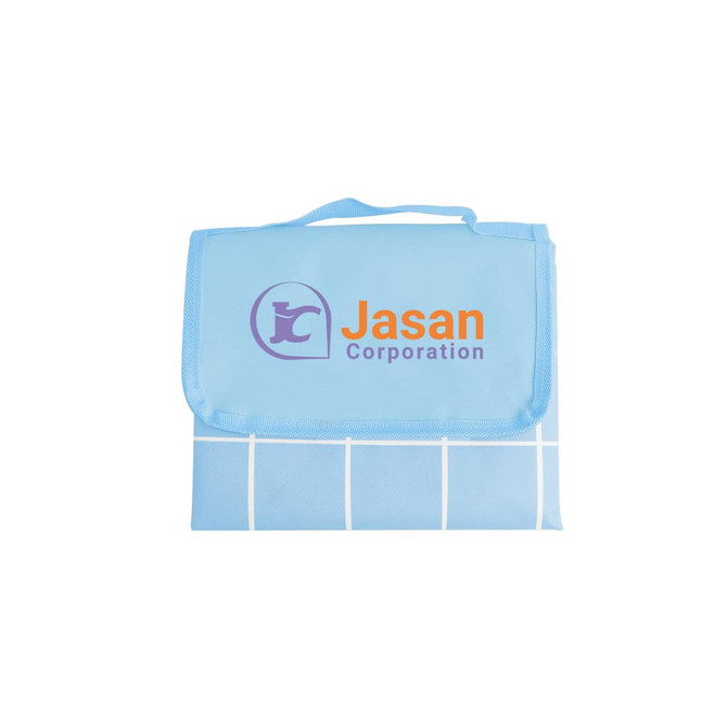 A large picnic blanket in blue featuring a grid pattern and a logo. Folds neatly with a carry handle.