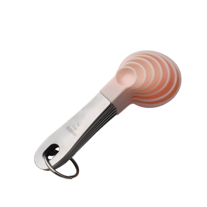A set of pink silicone measuring spoons with a stainless steel handle, attached by a metal keyring.