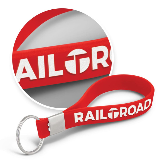 A red silicone key ring with an embossed design and a metal keyring attachment.