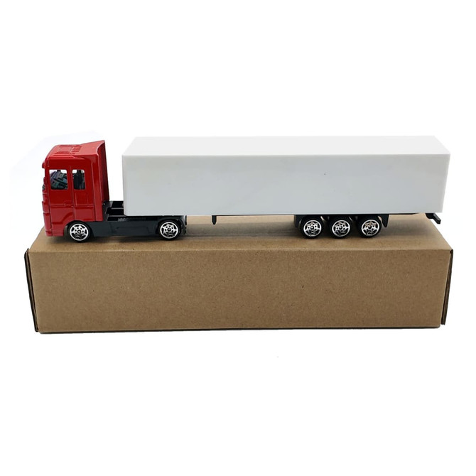 A red truck toy with a white trailer, displayed on a brown cardboard box. The truck features wheels and branding.