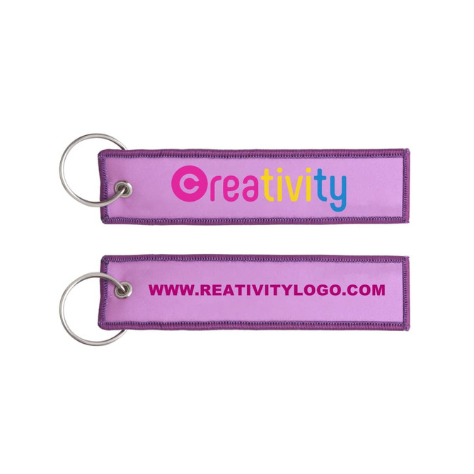 A purple woven key tag with a metal ring, featuring a logo and website on both sides.
