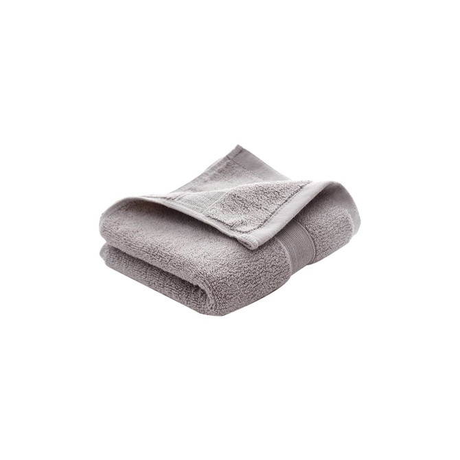 A folded grey embroidered cotton hand towel with a textured finish. It has a band around the centre and a logo.