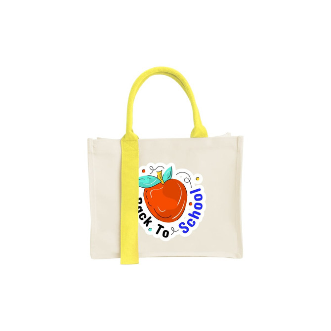 A cream horizontal canvas tote bag with a bright yellow handle and a graphic of an apple.