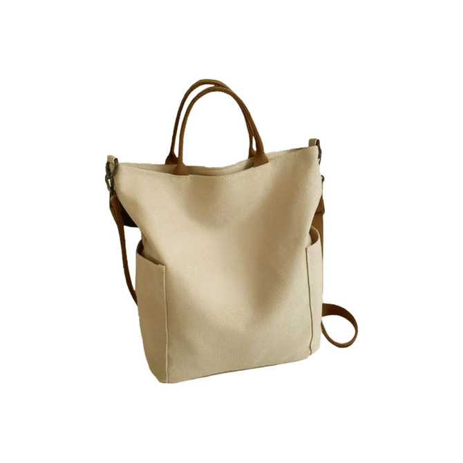 A vintage style canvas bag in cream with brown straps and pockets on the sides, featuring a logo.