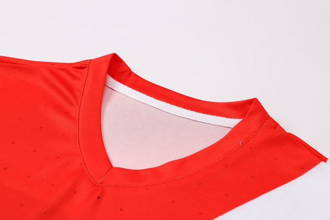 A red and white polyester football jersey featuring a V-neck design and a logo on the front.