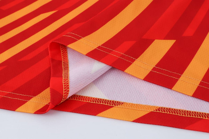 A vibrant red long sleeves shirt with bold yellow stripes, made of 100% polyester micro mesh. Features a logo.