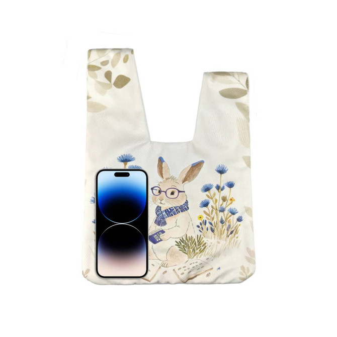 A wrist bag featuring a whimsical rabbit design with a floral background, alongside a smartphone for scale.