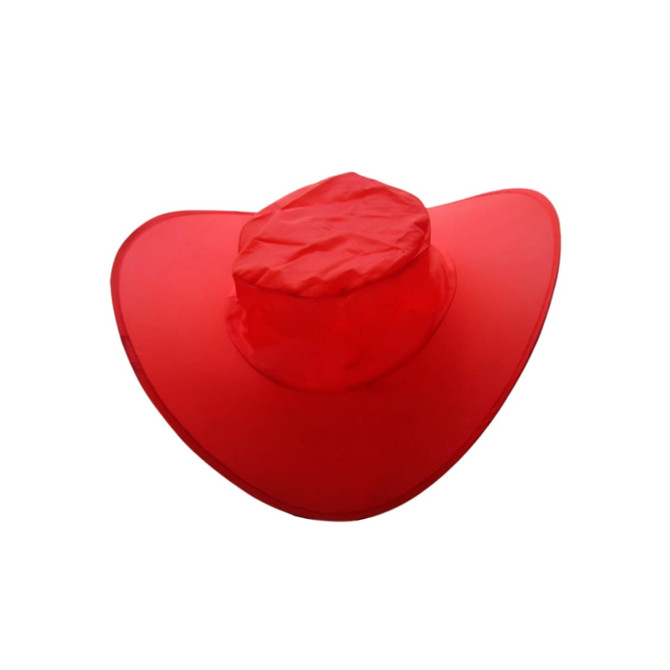 A foldable cowboy hat in bright red, featuring a wide brim and a central crown, neatly packed for storage.