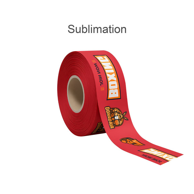 A red ribbon roll featuring bold graphics and branding designs. The ribbon is unspooled partially from its core.