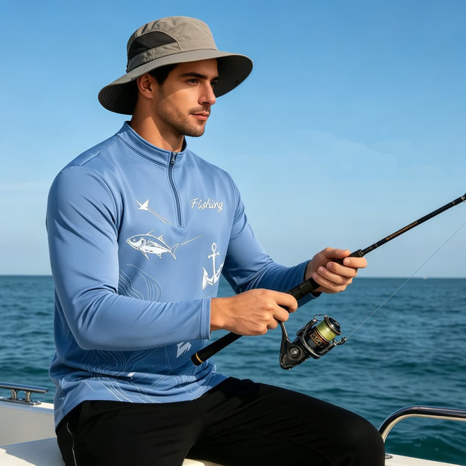 A man wearing a blue men's polyester spandex fishing pullover, sitting on a boat with a fishing rod.