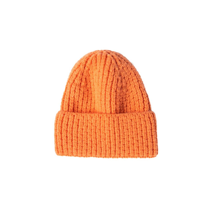 An orange twisted cable cuffed beanie with a ribbed texture. It features a logo on the side.