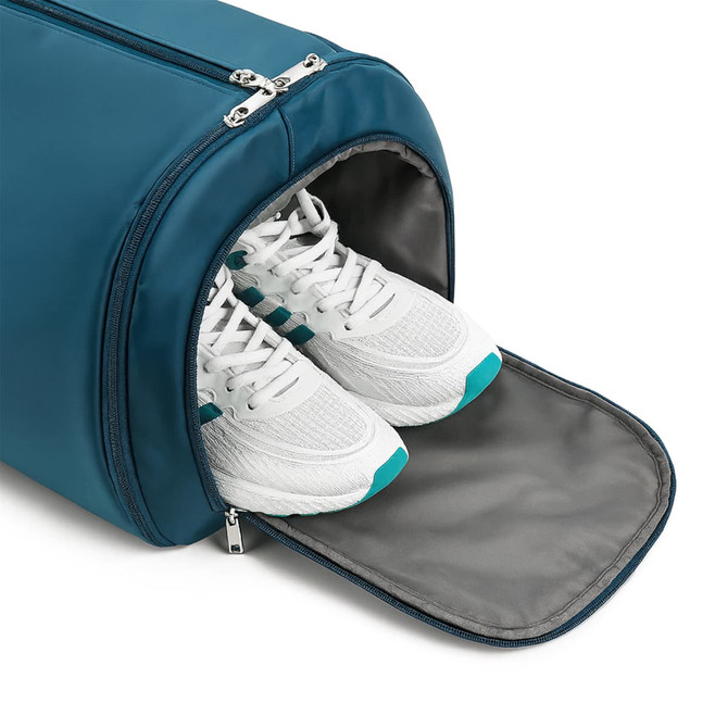 A teal duffel garment bag with a compartment containing white sneakers, showcasing a sleek design.