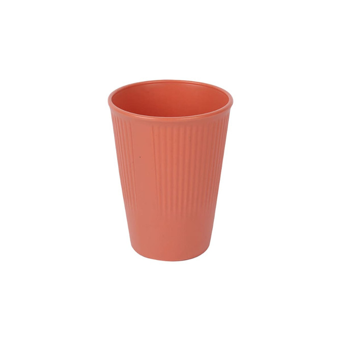 A wheat straw toothbrush cup in a coral colour with a ribbed texture and a logo.