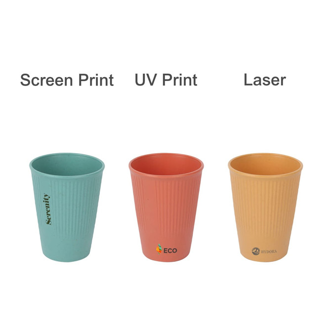Three wheat straw toothbrush cups in teal, coral, and beige, featuring ribbed designs and logos.