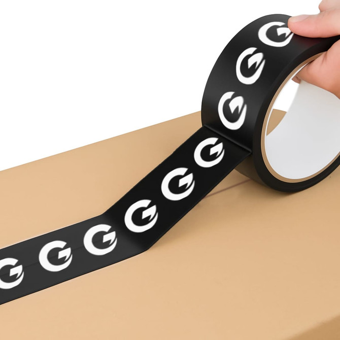 A roll of black BOPP packaging tape with a logo, being applied to a cardboard box.