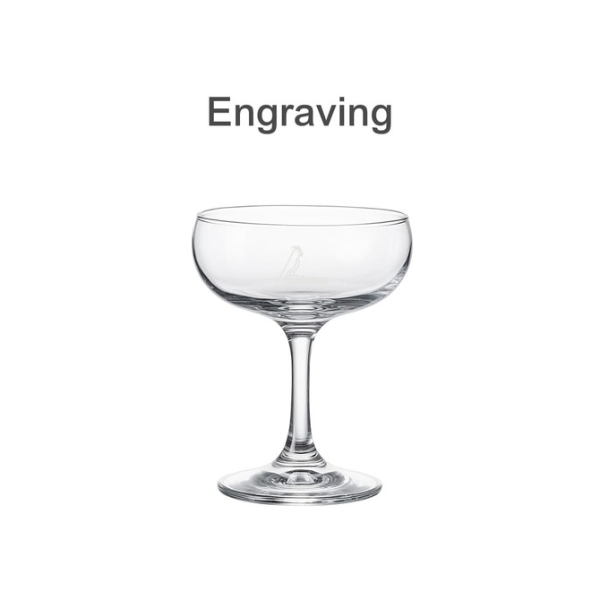 A clear glass martini coupe with a tall stem and a smooth, wide bowl. Features an engraving and a logo.