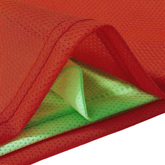A reversible training bib featuring red on one side and vibrant green on the other, made from 100% polyester mesh.