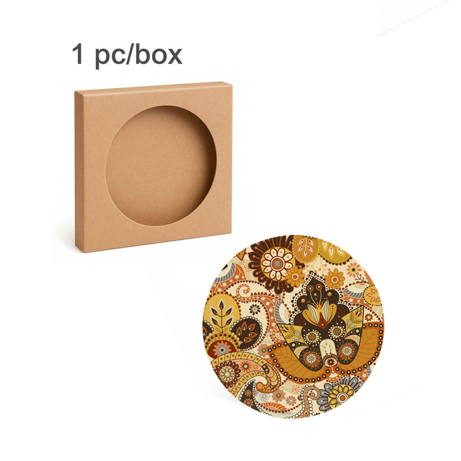 A round ceramic coaster featuring a vibrant, floral pattern, with a simple box for packaging in the background.