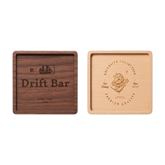 A square wooden coaster featuring a dark wood and a light wood side, each with unique engravings, including a logo.