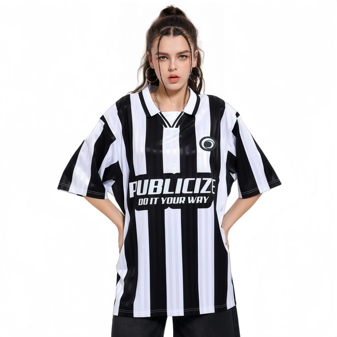 A loose-fitting, unisex polo jersey featuring bold black and white stripes and a prominent logo on the front.