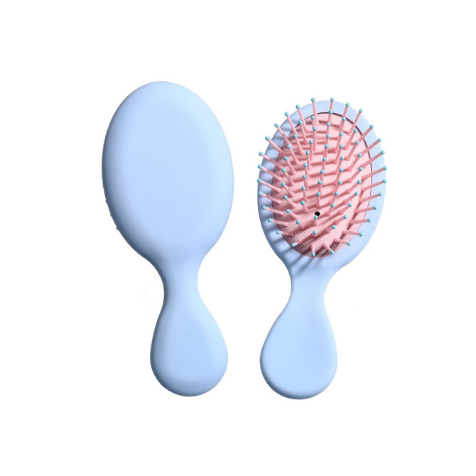 A light blue mini paddle brush with a pink bristle head, featuring a logo on the handle.