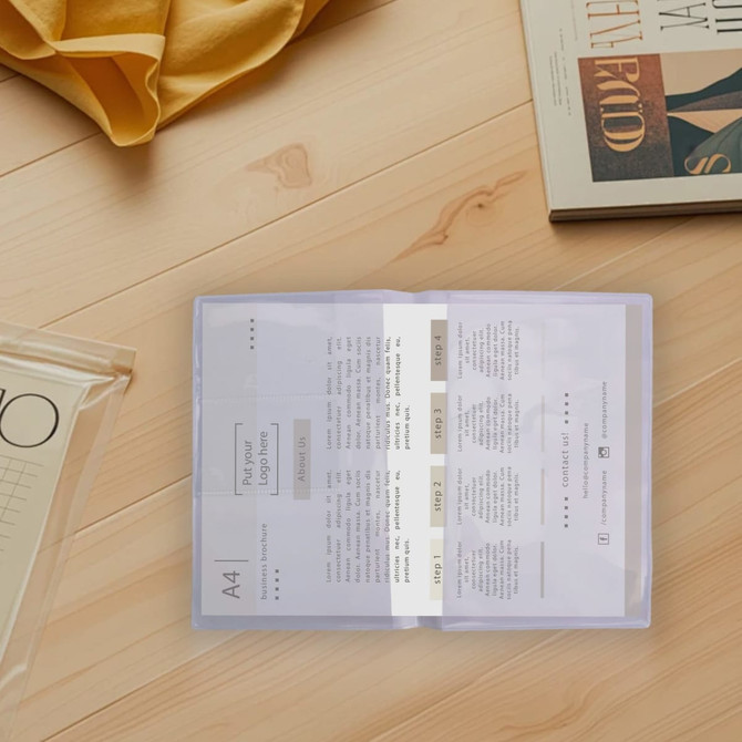A soft PVC folder in clear material, displayed on a wooden surface with papers inside and books nearby.