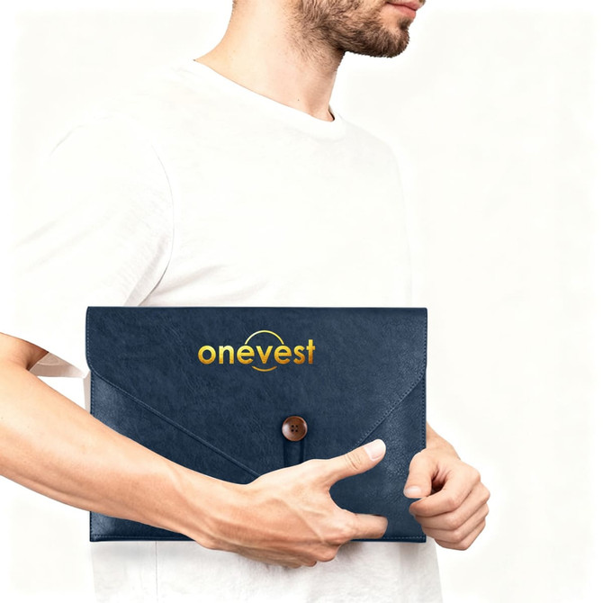 A navy PU leather folder with a button closure, featuring a logo on the front, held by a person.