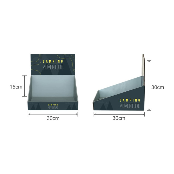 A corrugated cardboard counter display in dark grey and green, featuring an angled design for product placement.