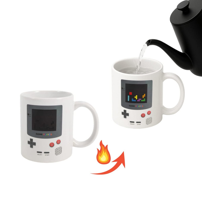 A heat-sensitive colour changing mug in white, resembling a retro gaming console, with a pouring kettle above.