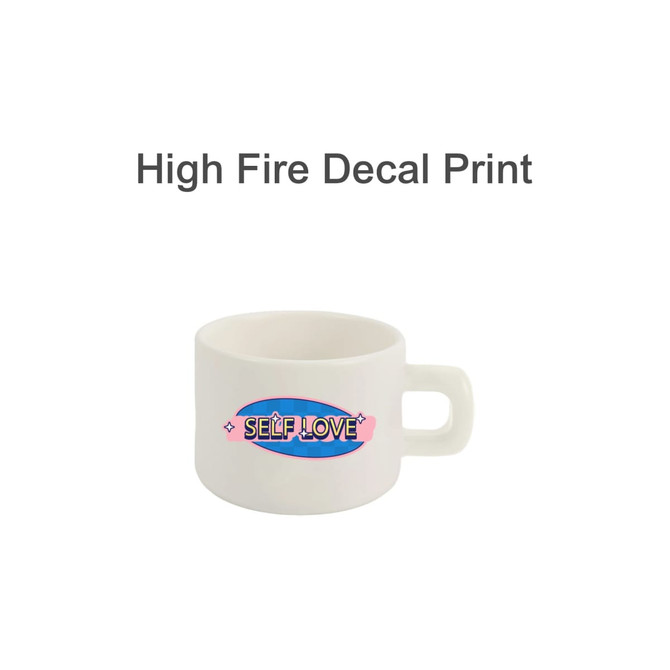 A ceramic mug in white featuring a vibrant design, including the phrase "Self Love," with a sturdy handle.