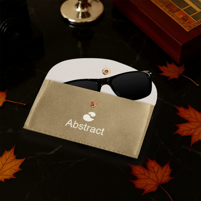 A gold PU leather glasses pouch with a white interior, holding a pair of black sunglasses. Features a logo.