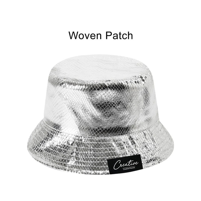 A silver bucket hat with a shiny, glittery finish and a woven patch on the side.