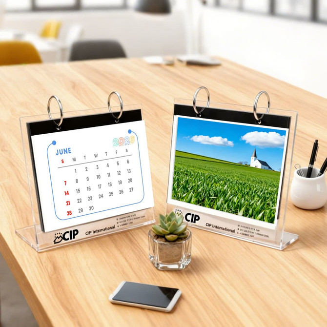 Acrylic desk calendar and photo album organizer with a white and blue design, featuring a green landscape image and a calendar page.