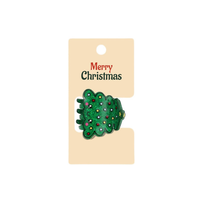 A green Christmas tree hair claw with colourful decorations, presented on a cardboard backing with a logo.