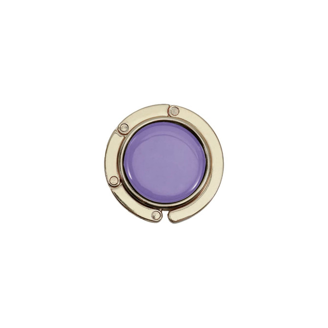 A round, foldable desk hook with a purple circular insert and a metallic gold frame. It includes a logo.