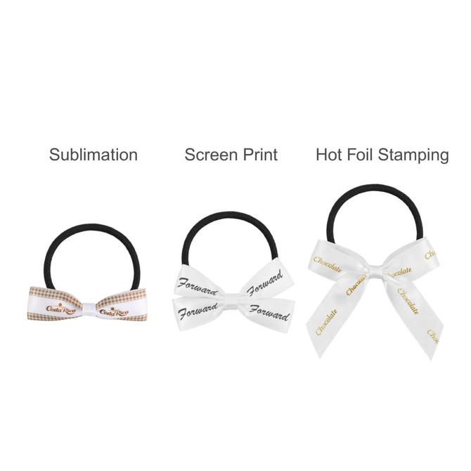 Three elastic hair bows in black, with white bows featuring various designs and printing styles.
