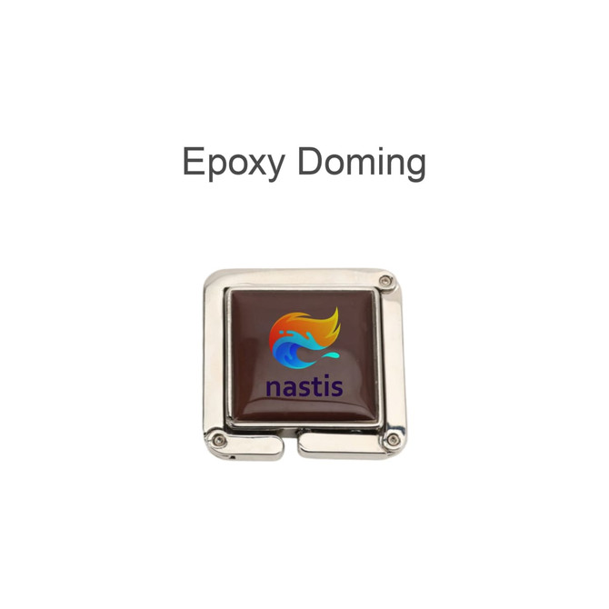 A square, foldable desk hook with a shiny silver finish and a coloured epoxy doming featuring a logo.