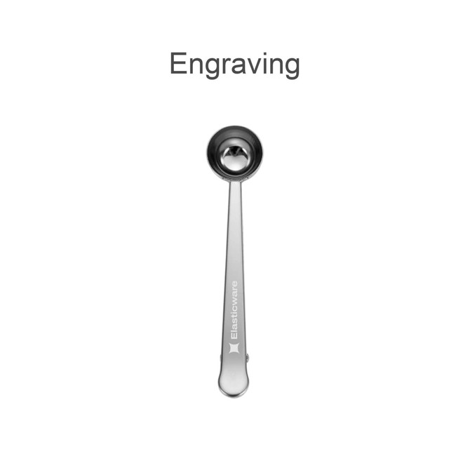 A stainless steel coffee measuring spoon with a clip, featuring a branded logo.