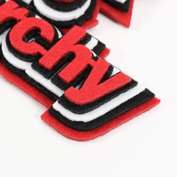 Custom felt logo hanging tags in red, black, and white, showcasing layered design elements without visible text.