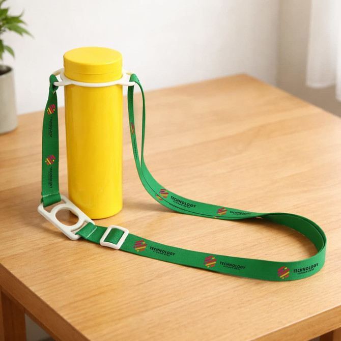 A drink bottle in yellow with a green lanyard attached, featuring logos, resting on a wooden surface.