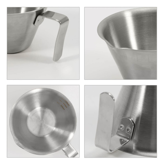 A stainless steel espresso measuring cup with a handle, featuring a smooth, shiny surface and measurement markings.