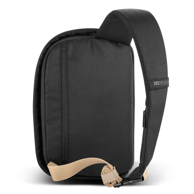 A black sling bag with a tan strap and a zipper pocket, featuring a logo on the strap.
