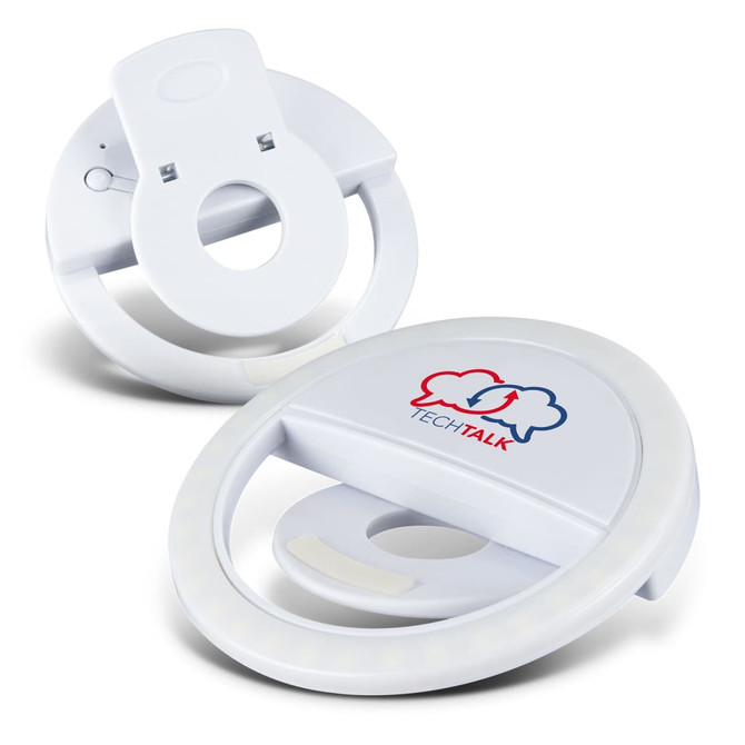 A white selfie phone light with a circular design, featuring a logo on the front and a clip for attachment.