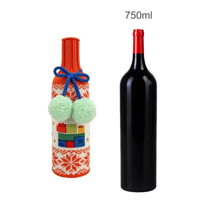 A drink bottle with a custom knitted sleeve featuring an orange and cream design, adorned with green pom-poms.