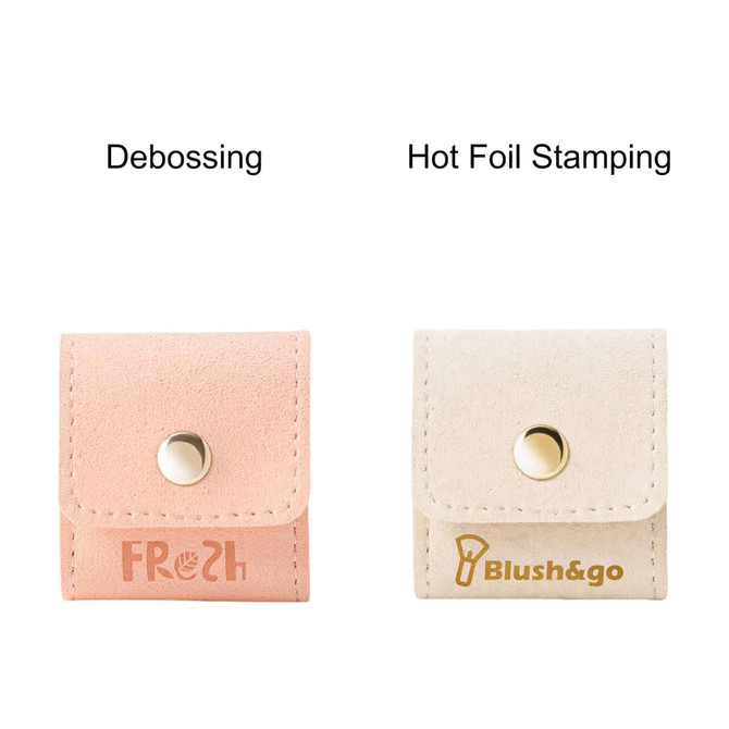 A mini synthetic leather jewellery bag in pink with debossing and a cream bag with hot foil stamping, each featuring a snap closure.