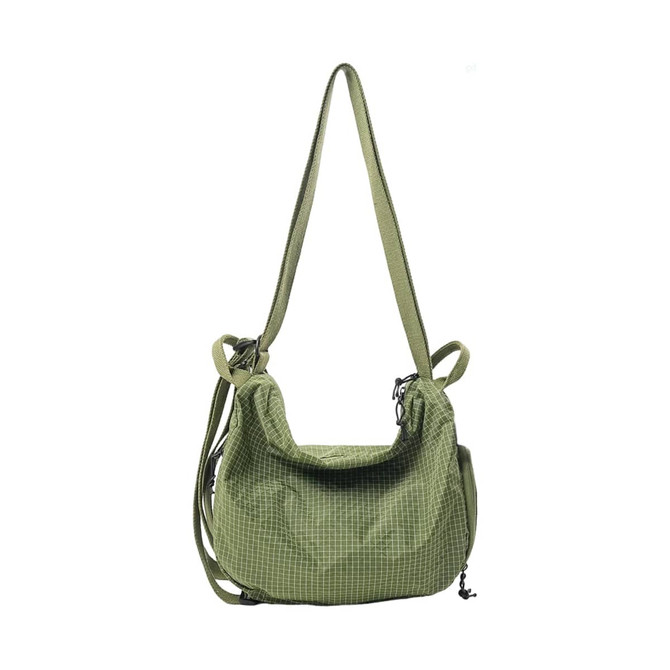 A green convertible backpack duffel bag with a textured pattern and adjustable strap. It features a logo.