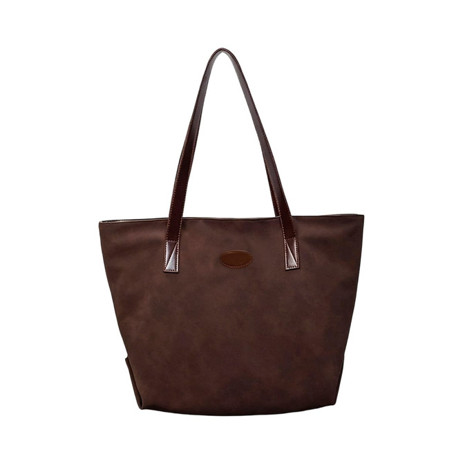A brown suede leather tote bag with dark leather handles and a branding logo.